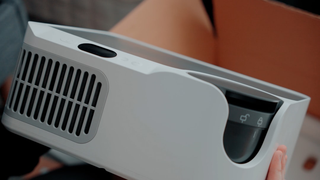 A white projector with ventilation slits.